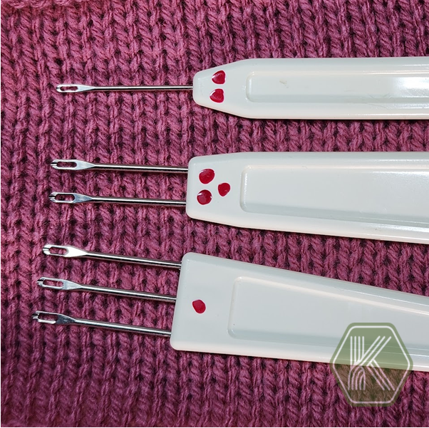 Transfer tool used to move stitches from one needle to another